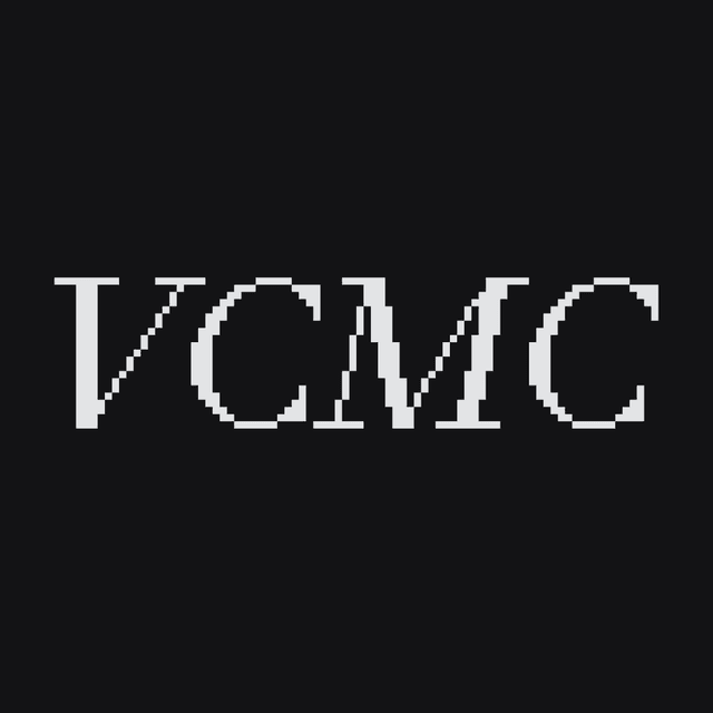 VCMC wordmark on dark background
